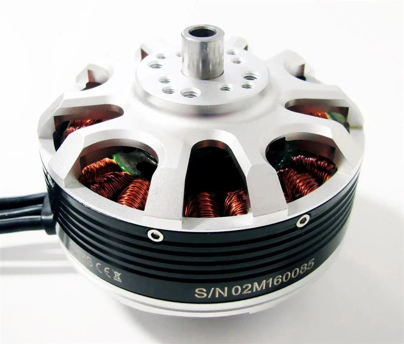 Brushless motor for UAS drone, silver housing with copper windings and central shaft hole.