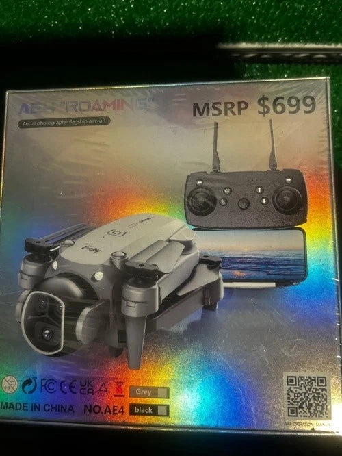 Grey quadcopter drone and remote controller in retail box packaging