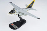 1/72 scale gray fighter jet model with yellow tail, mounted on black display stand