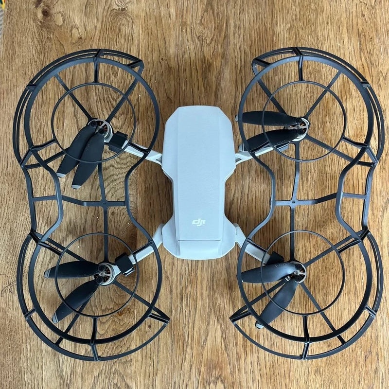 DJI Mavic Mini drone top view with four propellers and light gray body