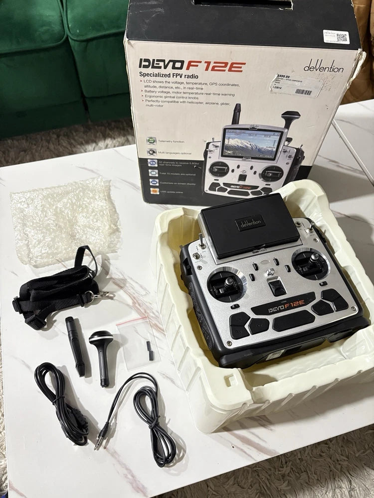 DeVention DEVO F12E FPV radio transmitter with dual joysticks, screen, and accessory cables