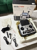DeVention DEVO F12E FPV radio transmitter with dual joysticks, screen, and accessory cables