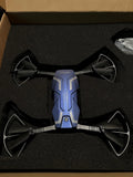 Blue folding quadcopter drone with four propellers and onboard HD camera