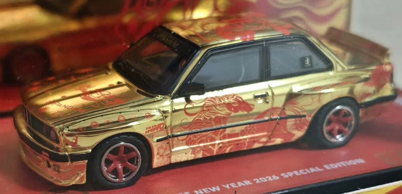 Golden and red patterned 1:64 model car with black hood, front three-quarter view on base