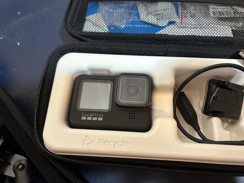 Black GoPro HERO9 action camera in a hard zip case with mounts and cable