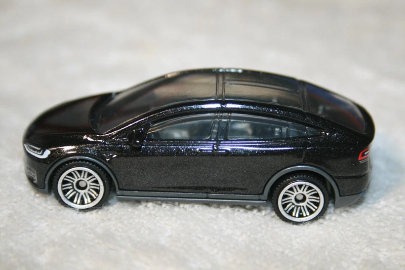 Black metallic die-cast Tesla Model X toy car, side profile