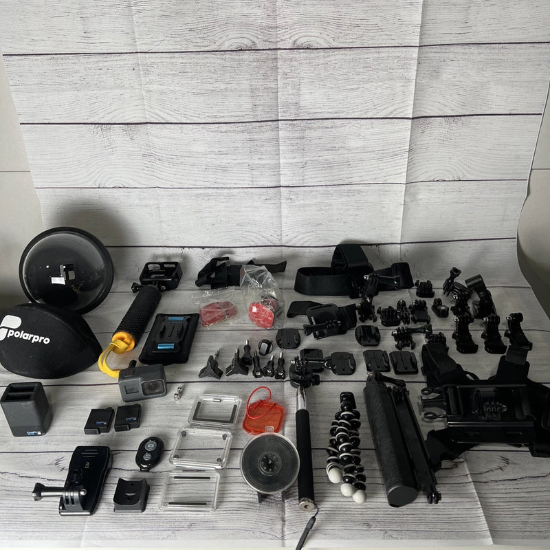 GoPro Hero 5 action camera kit with multiple black mounts, grips, and accessory cases