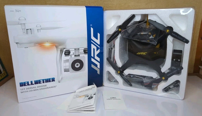 Black JJRC H68 aerial drone with 4 rotors in retail box tray