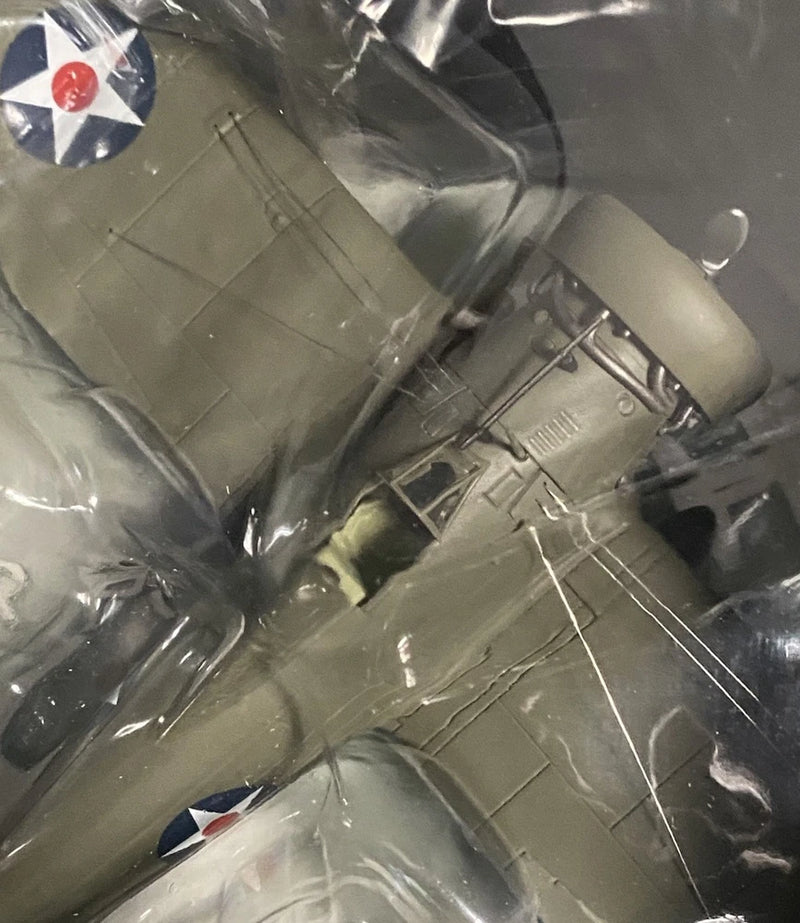 Gray WWII-style model airplane with wings and nose, inside clear display packaging