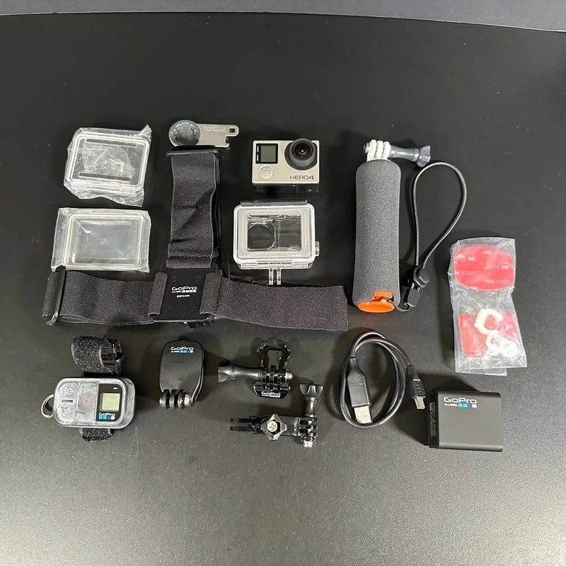 Silver action camera bundle with waterproof housing, mounts, cables, battery, and accessories