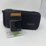 Black GoPro mini action camera with front lens, shown with black carrying case