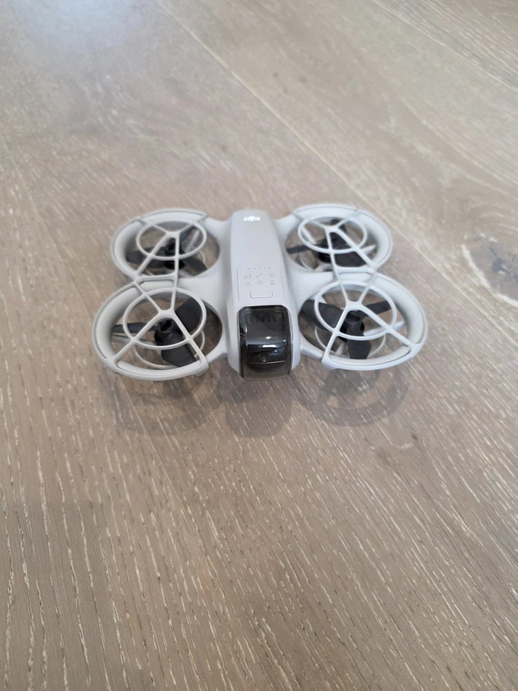DJI Neo quadcopter with propellers and attached battery pack