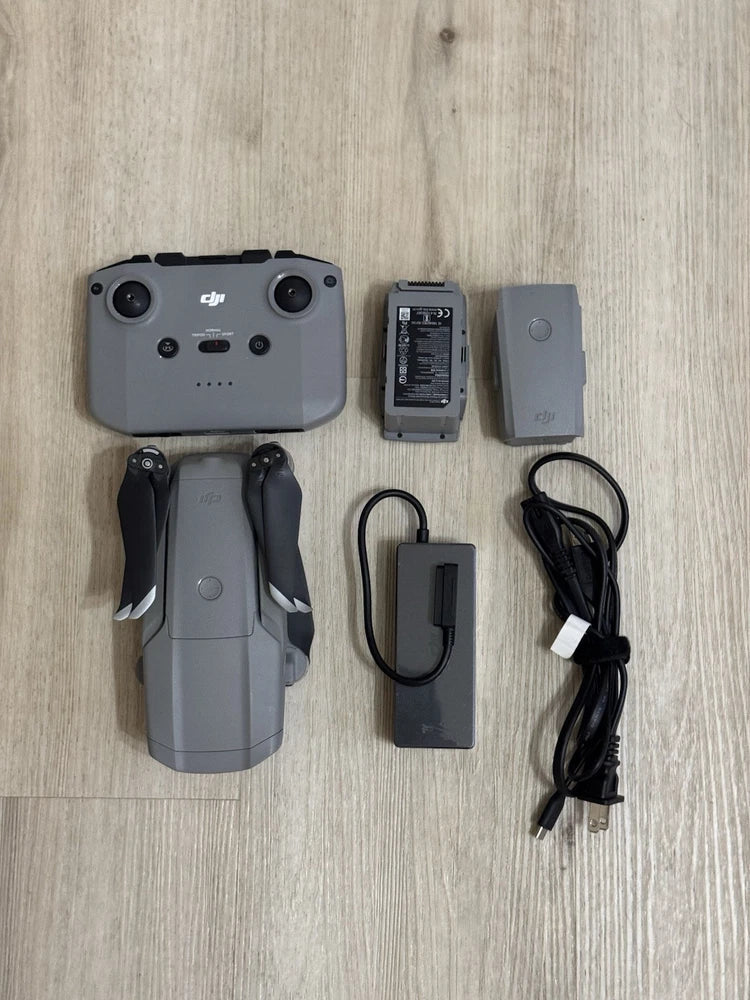 DJI Mavic Air 2 drone with controller, battery, and charging cable, light gray