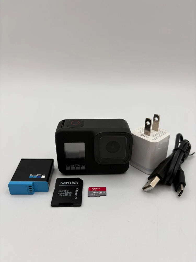 Black action camera bundle with SD card, charger plug, and case