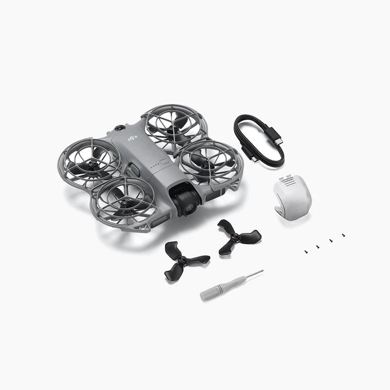 Gray quadcopter drone body with propellers, cable, and spare parts
