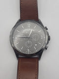 Men's chronograph wristwatch with gray dial, three subdials, and brown leather strap