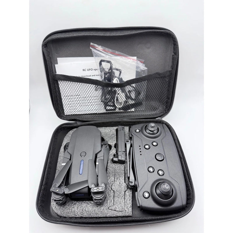 Black folding mini RC UFO quadcopter and remote inside zippered carrying case
