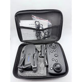 Black folding mini RC UFO quadcopter and remote inside zippered carrying case