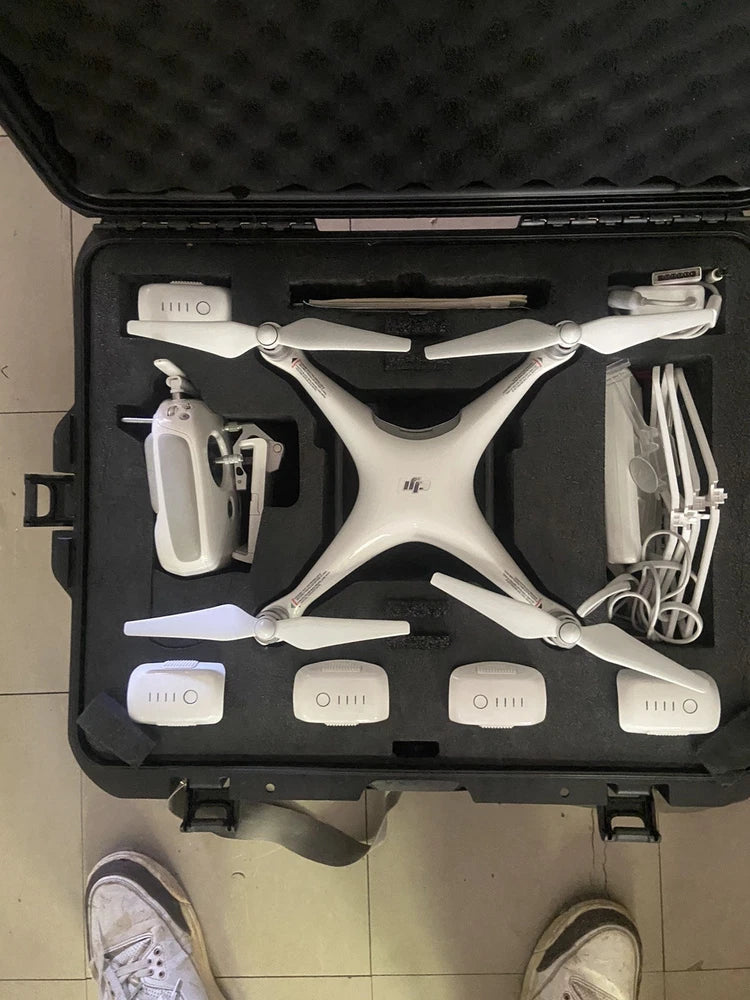 White DJI Phantom 4 quadcopter drone with propellers in hard case
