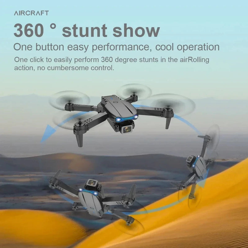 Two grey quadcopter drones with FPV cameras and blue status lights