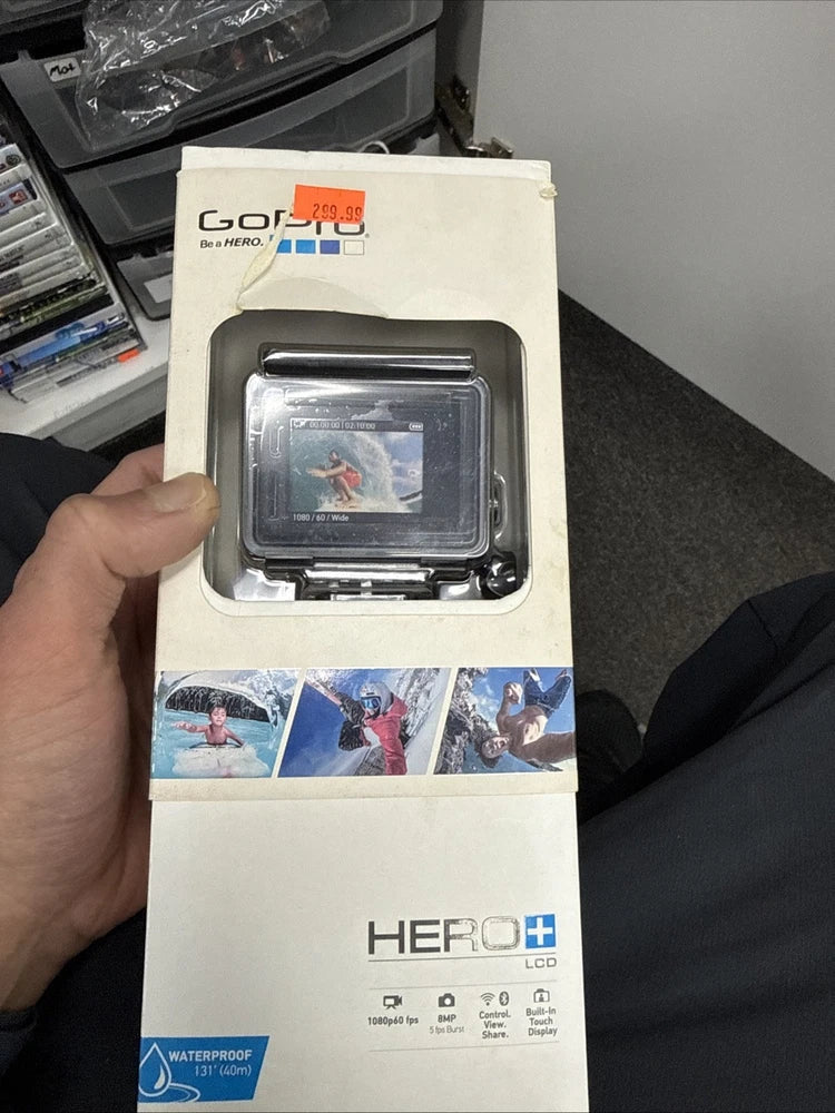 GoPro HERO action cam in retail box with waterproof housing, LCD screen visible