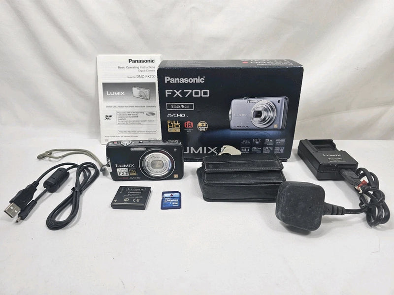 Panasonic compact camera kit with box, case, charger, cables, and 2GB SD card