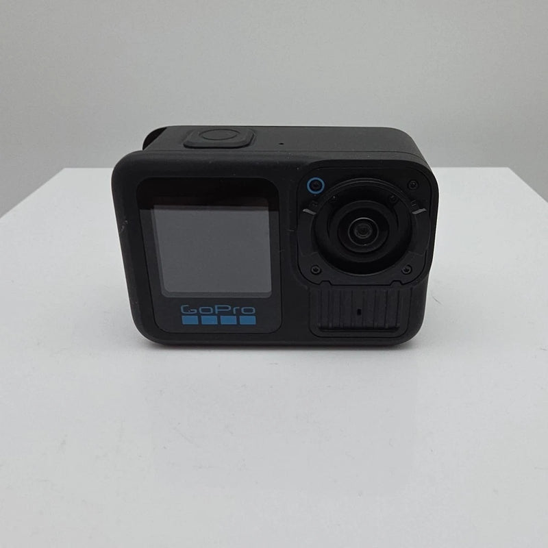 Black action camera with front lens and cracked screen display