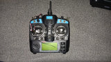 Black remote control transmitter with blue accents, LCD screen, and dual antennas