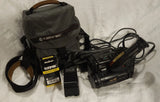 Handheld Hi-8 camcorder with shoulder strap, battery pack, and connected cables
