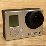 GoPro HERO3+ action camera with black lens and LCD screen, silver body