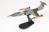 1/72 F-104G Starfighter model plane on black display stand, gray with green and orange markings