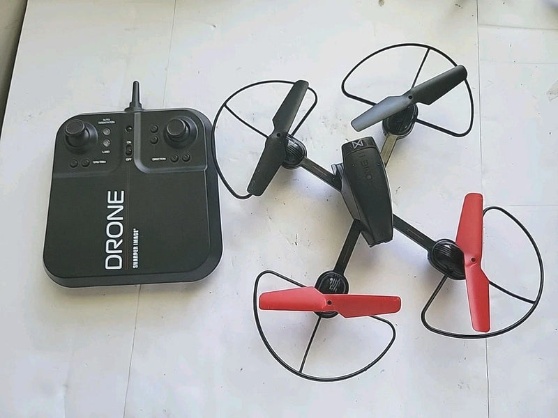 Black RC drone with stream camera beside controller remote