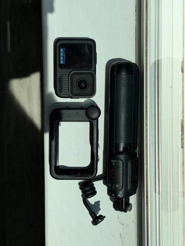 GoPro HERO13 Black action camera in protective housing with attached cylindrical mount