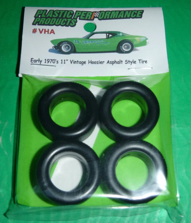 Four black 1/25 model asphalt tires set in sealed plastic packaging