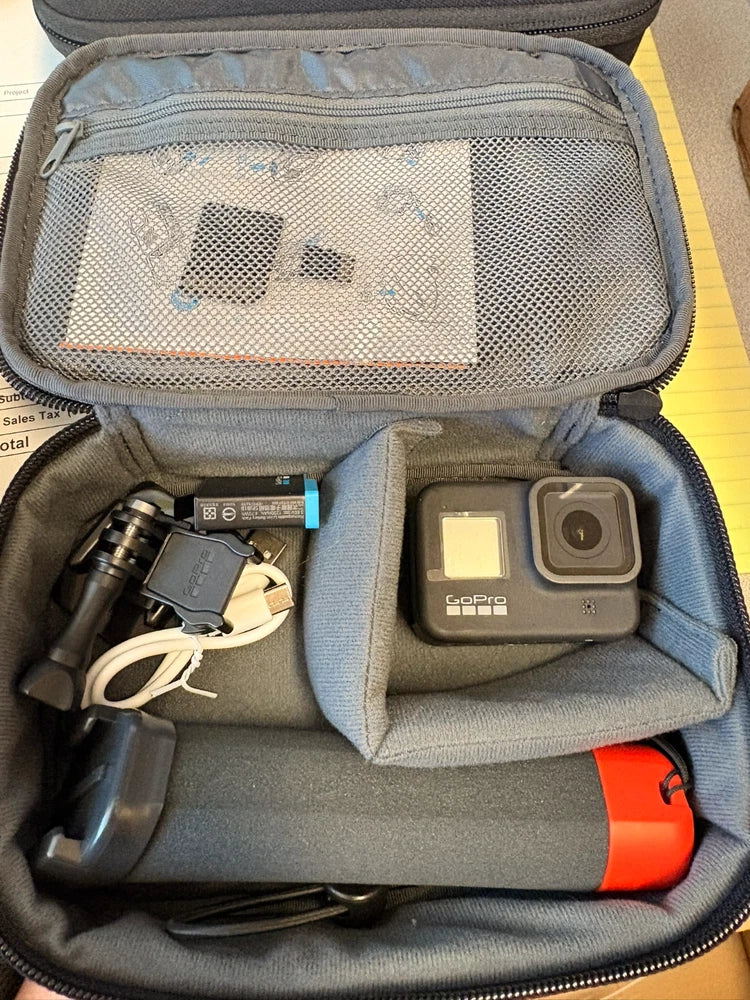 GoPro HERO action camera bundle with open case, camera, battery, and mounts