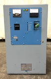 Industrial battery charger control panel, blue enclosure with meters, switches, and connectors.