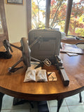 4drc drone kit with open case, folded drone, controller, cables, and manuals
