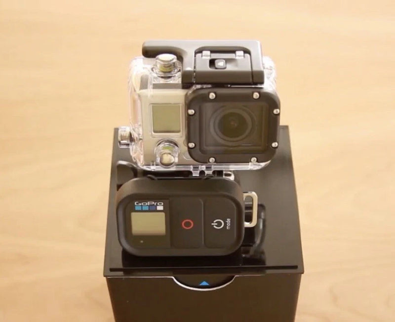 GoPro action camera in clear waterproof housing with rear display and buttons