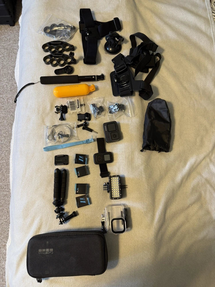 GoPro HERO 9 action camera bundle with camera housing, mounts, remote, and carrying case