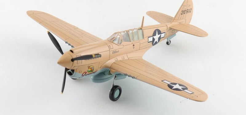 Tan WWII fighter aircraft model with spinning propeller, camouflage nose, and star insignia