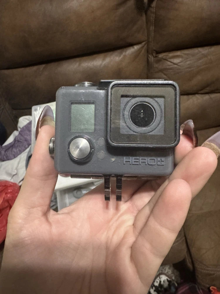 Grey GoPro Hero Plus action camera housing with front lens and control buttons