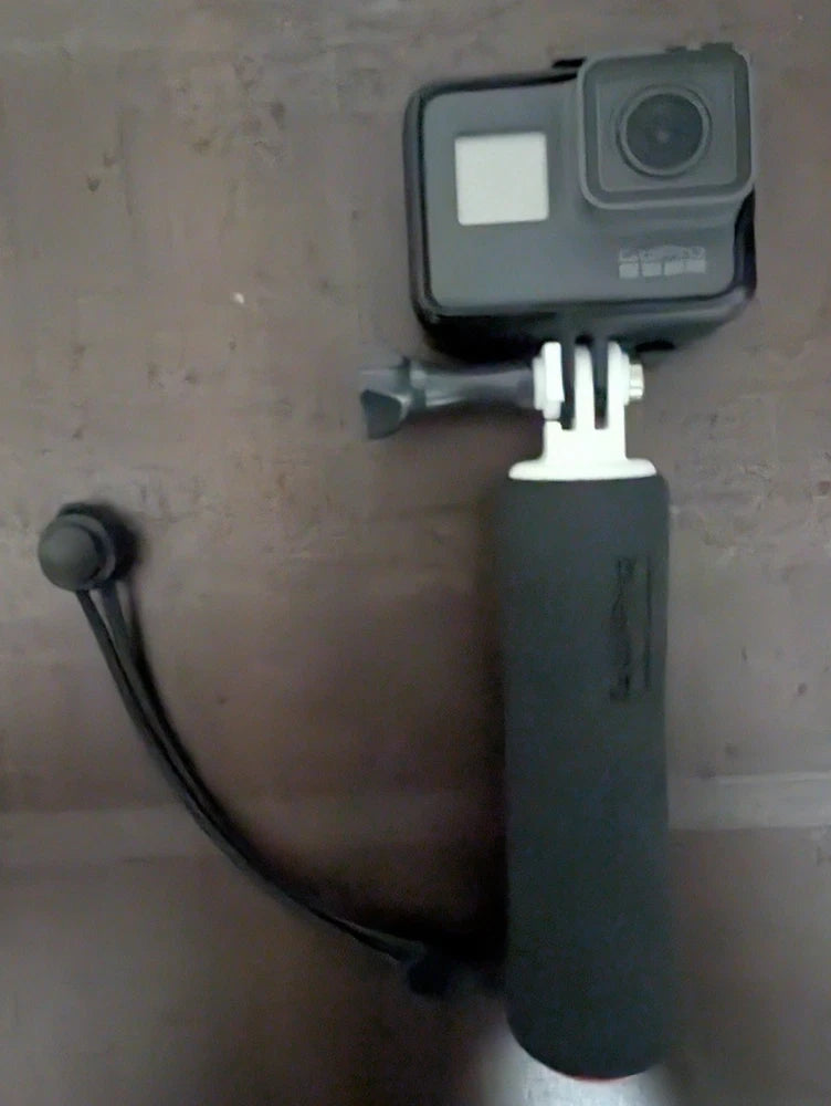 GoPro Hero5 action camera with black handheld grip and mounting base