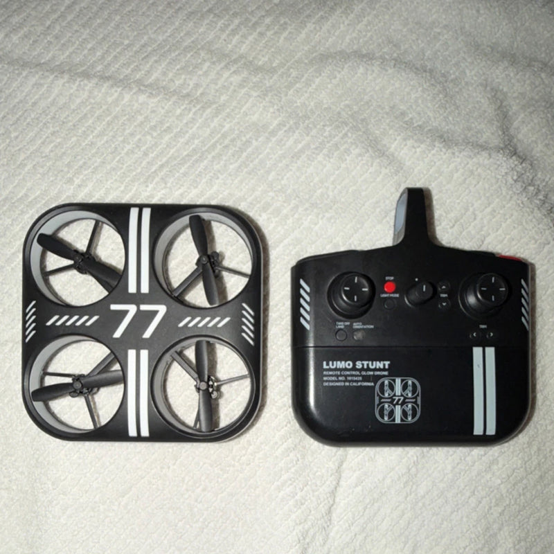LED stunt quadcopter drone with four rotors and handheld controller