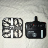 LED stunt quadcopter drone with four rotors and handheld controller
