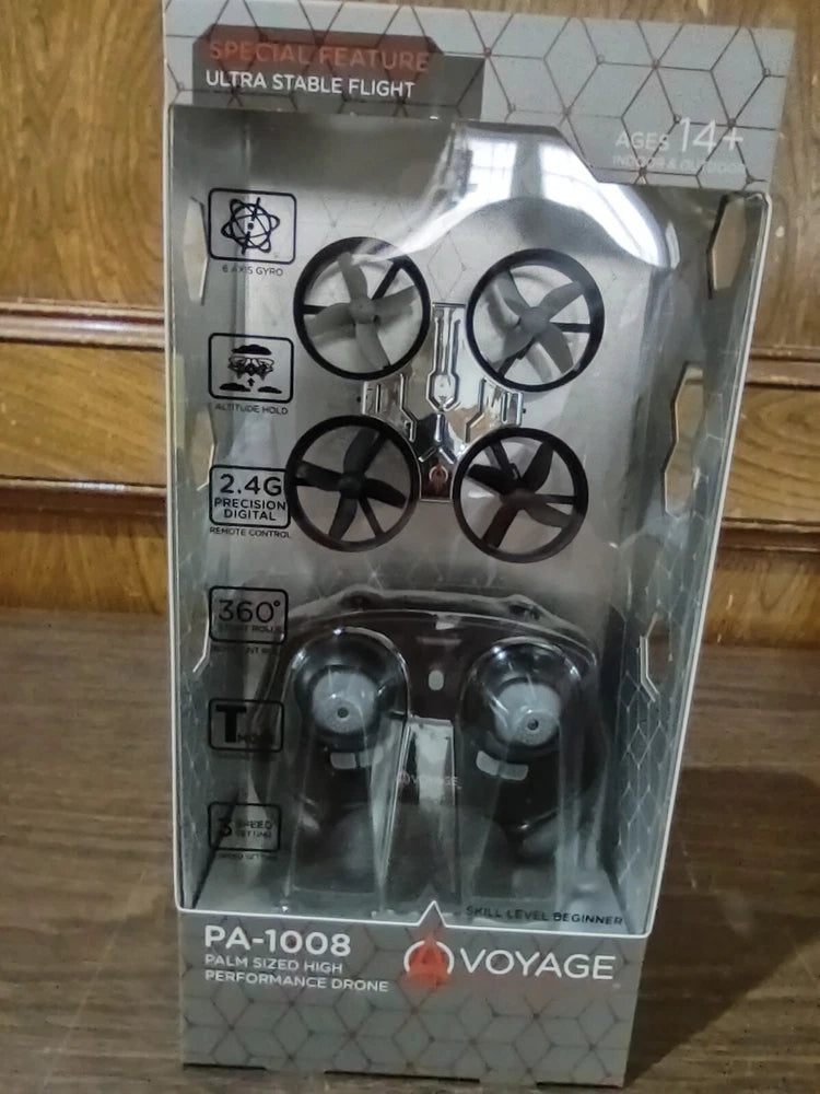 VOYAGE palm-sized RC drone in retail box with 4 propellers, 2.4G remote.