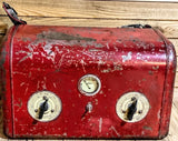 Vintage red battery charger with three round terminals and center control knob