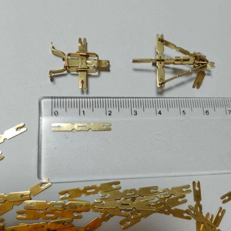 Brass metal model airplane parts kit, small brass pieces on clear tray