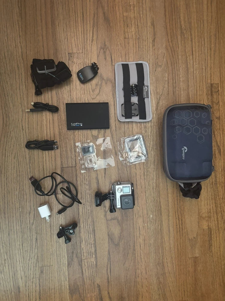Used GoPro HERO4 action camera bundle with dark case, head strap, cables