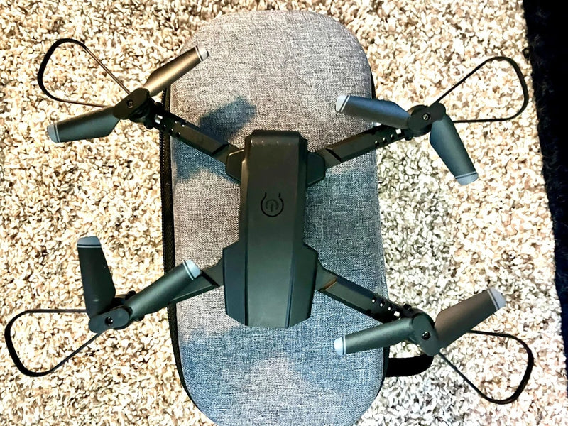Mini quadcopter drone toy with four black propellers and central controller