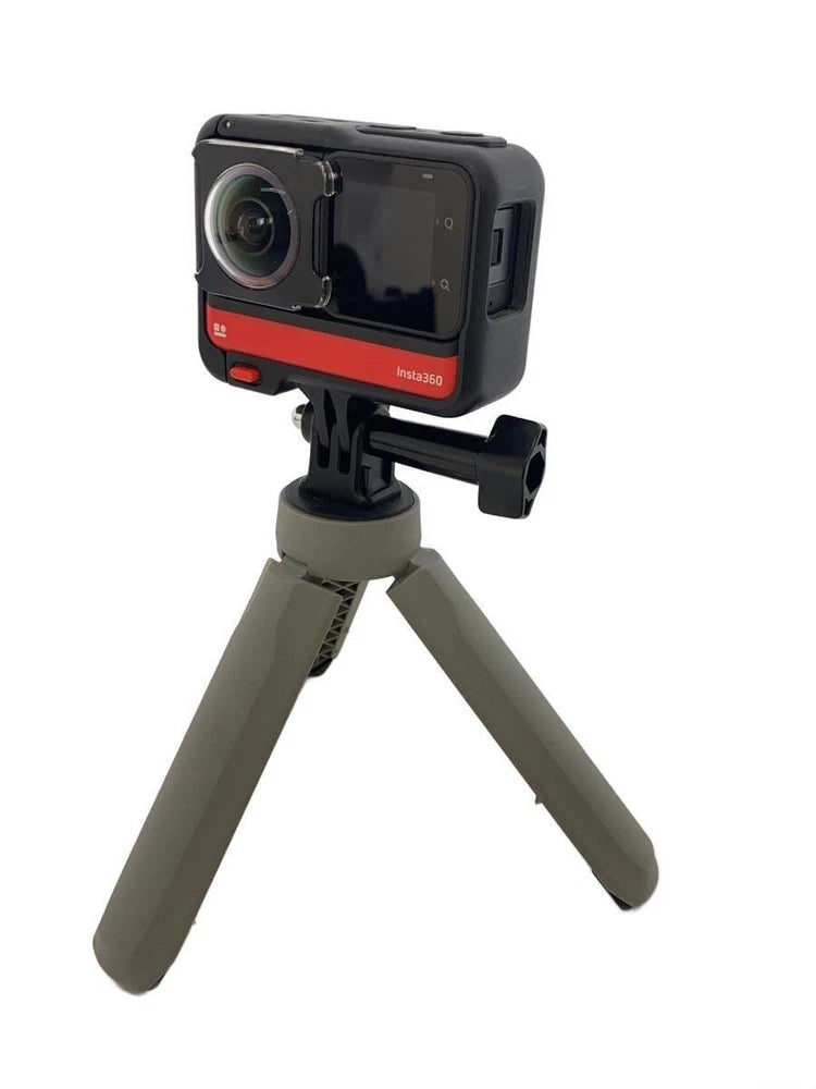 Insta360 ONE RS action cam with protective housing on small tripod stand